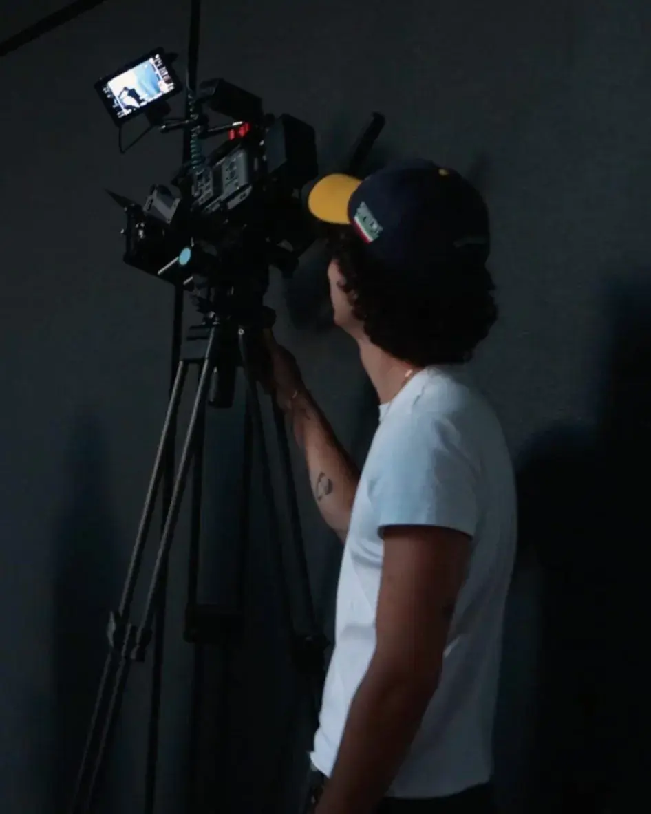 Camera operator filming on set.